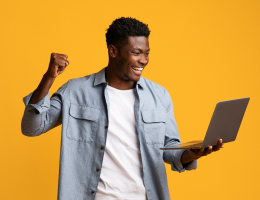 emotional-african-american-guy-holding-laptop-image