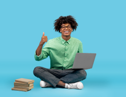 happy-african-american-teen-guy-sitting-on-floor-image