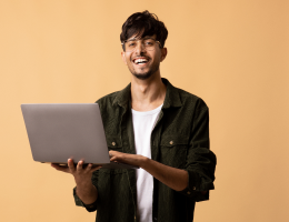 happy-indian-guy-freelancer-using-modern-laptop-image